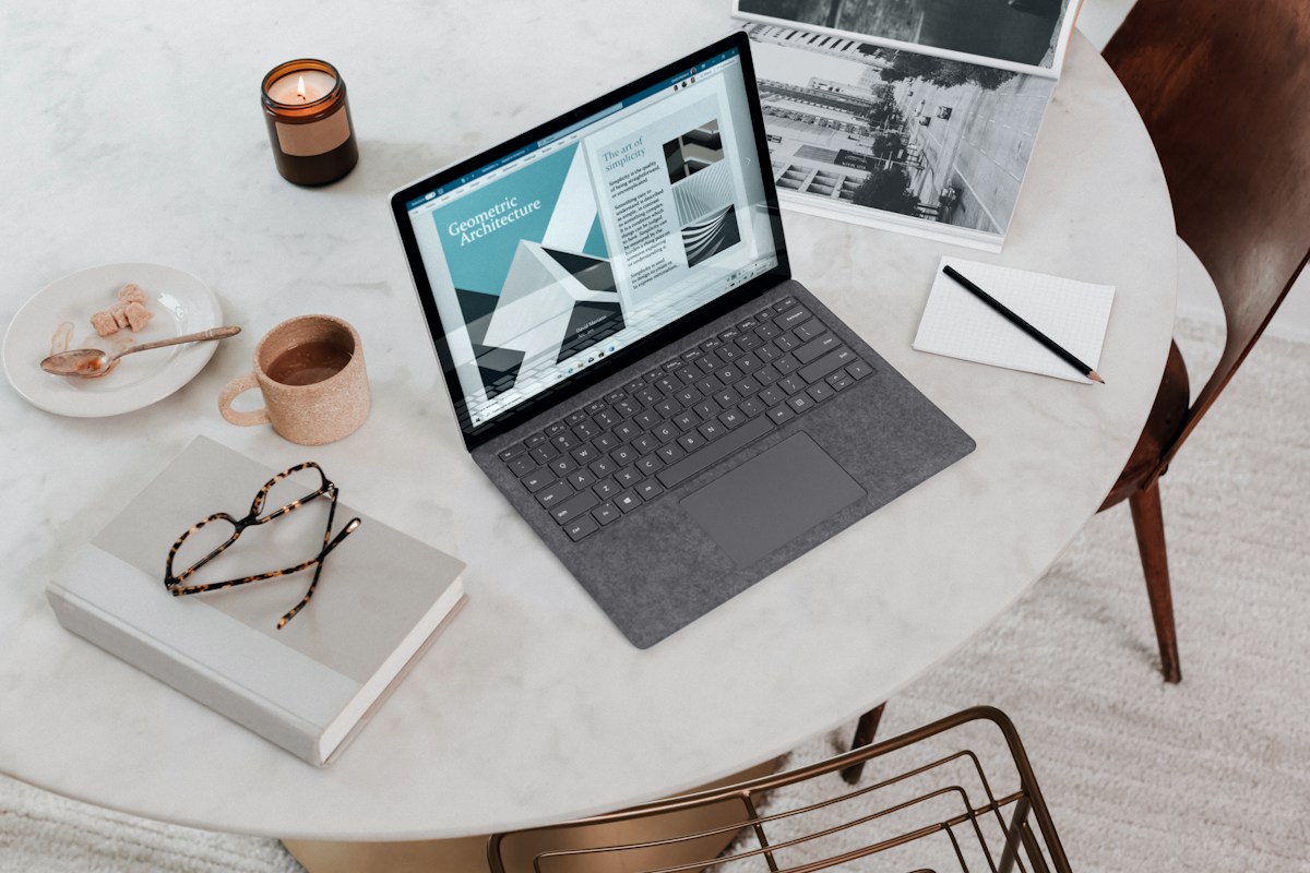 An organized desk with a laptop and notebook for remote work